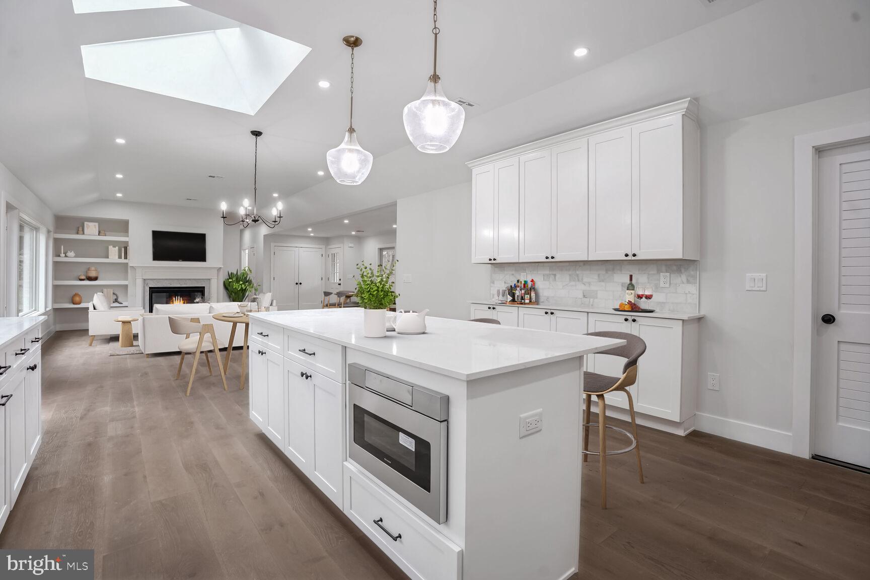 358 A Cherry Valley Road Princeton, NJ 08540 - Photo 24 of 28 a kitchen with stainless steel appliances kitchen island a white cabinets and couches with wooden floor