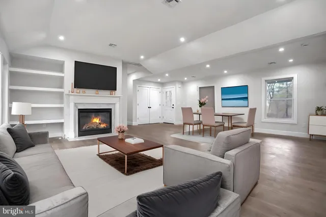 a living room with furniture flat screen tv and a fireplace