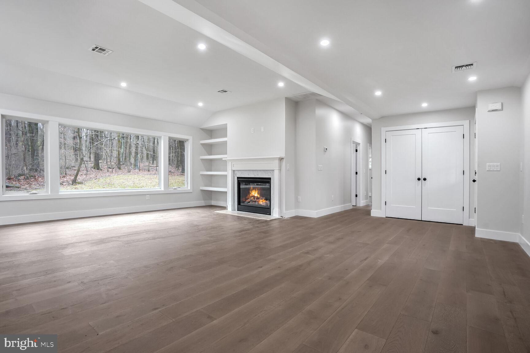 358 A Cherry Valley Road Princeton, NJ 08540 - Photo 3 of 28 a view of an empty room with a fireplace and a window