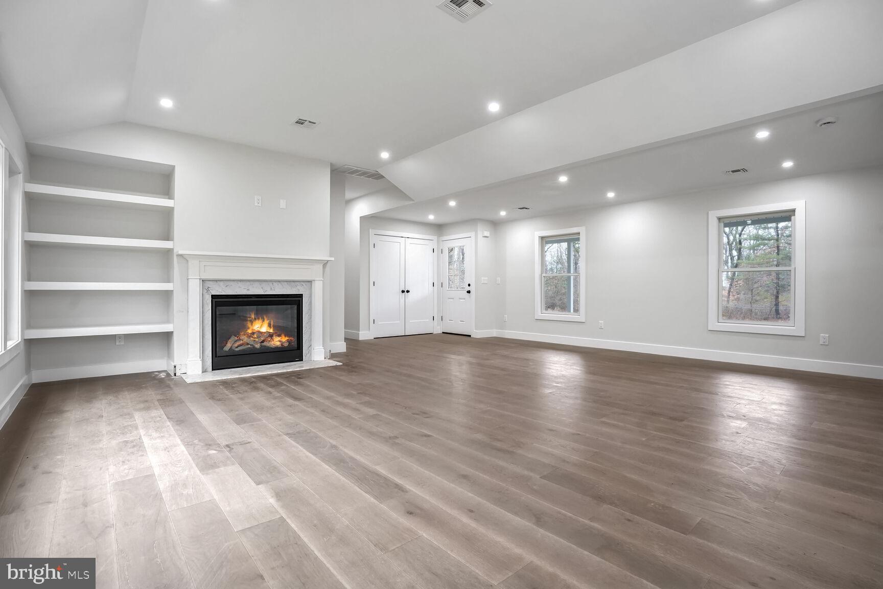 358 A Cherry Valley Road Princeton, NJ 08540 - Photo 4 of 28 a view of an empty room with a fireplace and a window