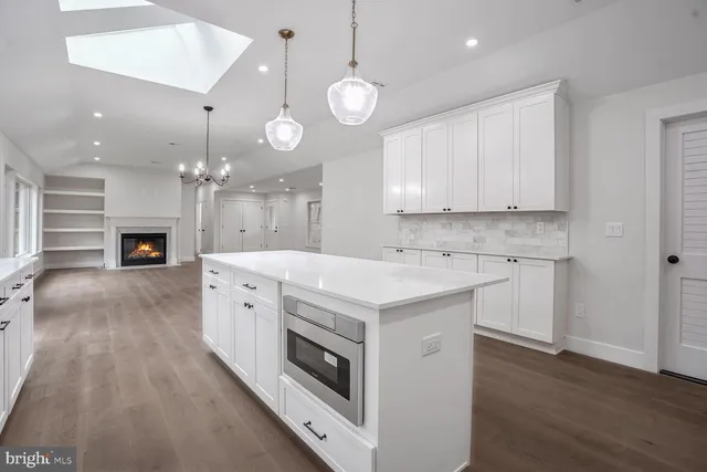 a view of kitchen with sink microwave and stove