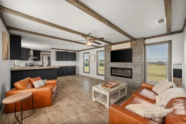 a living room with fireplace furniture and a flat screen tv
