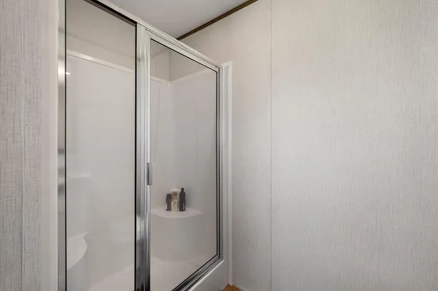 a bathroom with a glass shower door