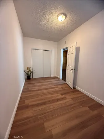 a view of a livingroom with wooden floor and a potted plant