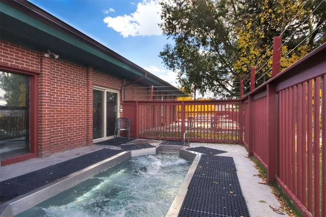 a view of a house with a wooden fence
