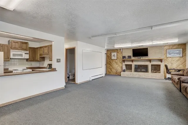 a kitchen with kitchen island white cabinets and stainless steel appliances