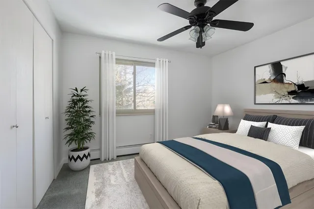 a bedroom with a bed and a window