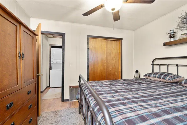 a bedroom with a bed a chandelier and closet
