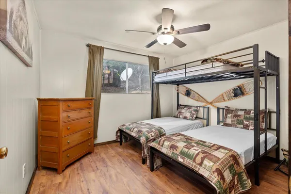 a bedroom with a bed and wooden floor