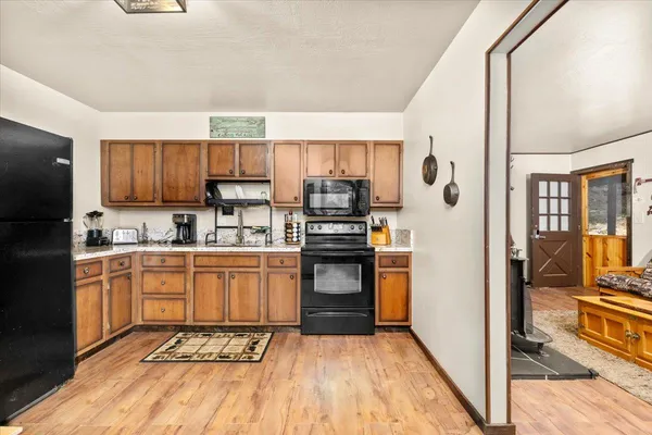 a kitchen with stainless steel appliances granite countertop a refrigerator and a sink