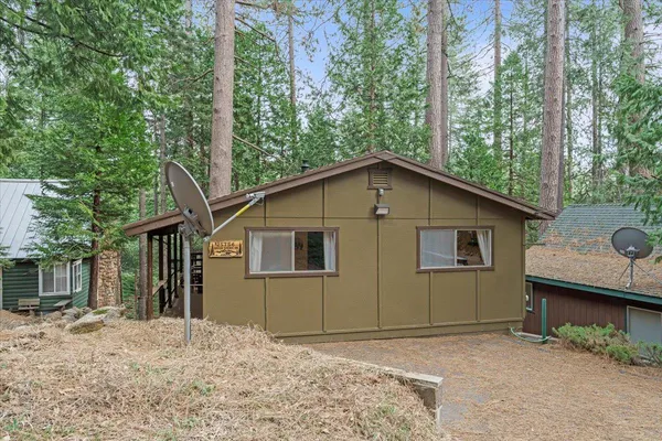 a view of a house with a backyard and balcony