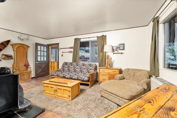 a living room with furniture pool table and a flat screen tv