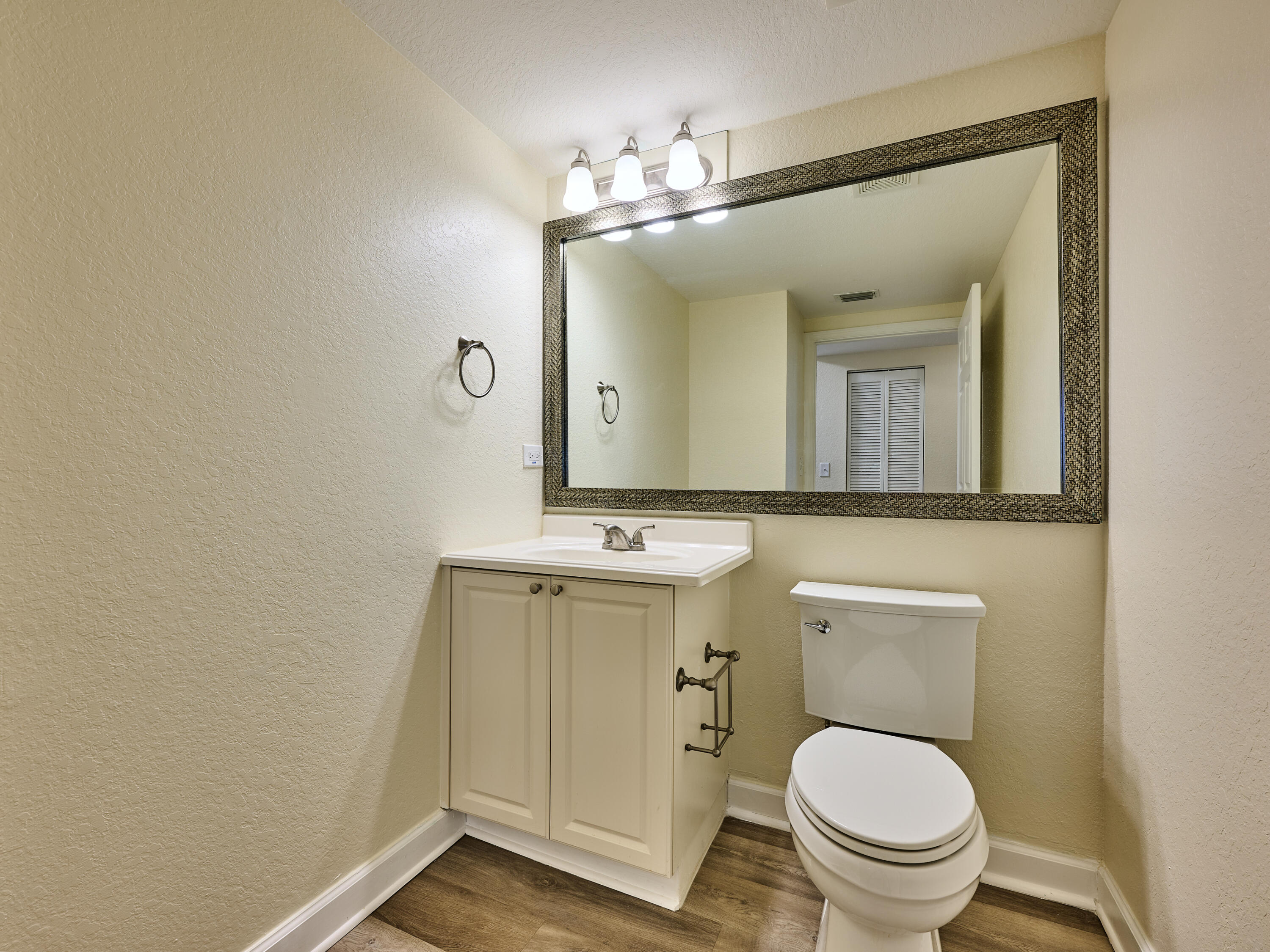 6344 West Sample Road, Unit 6344 Coral Springs, FL 33067 - Photo 14 of 30 a bathroom with a toilet sink and mirror