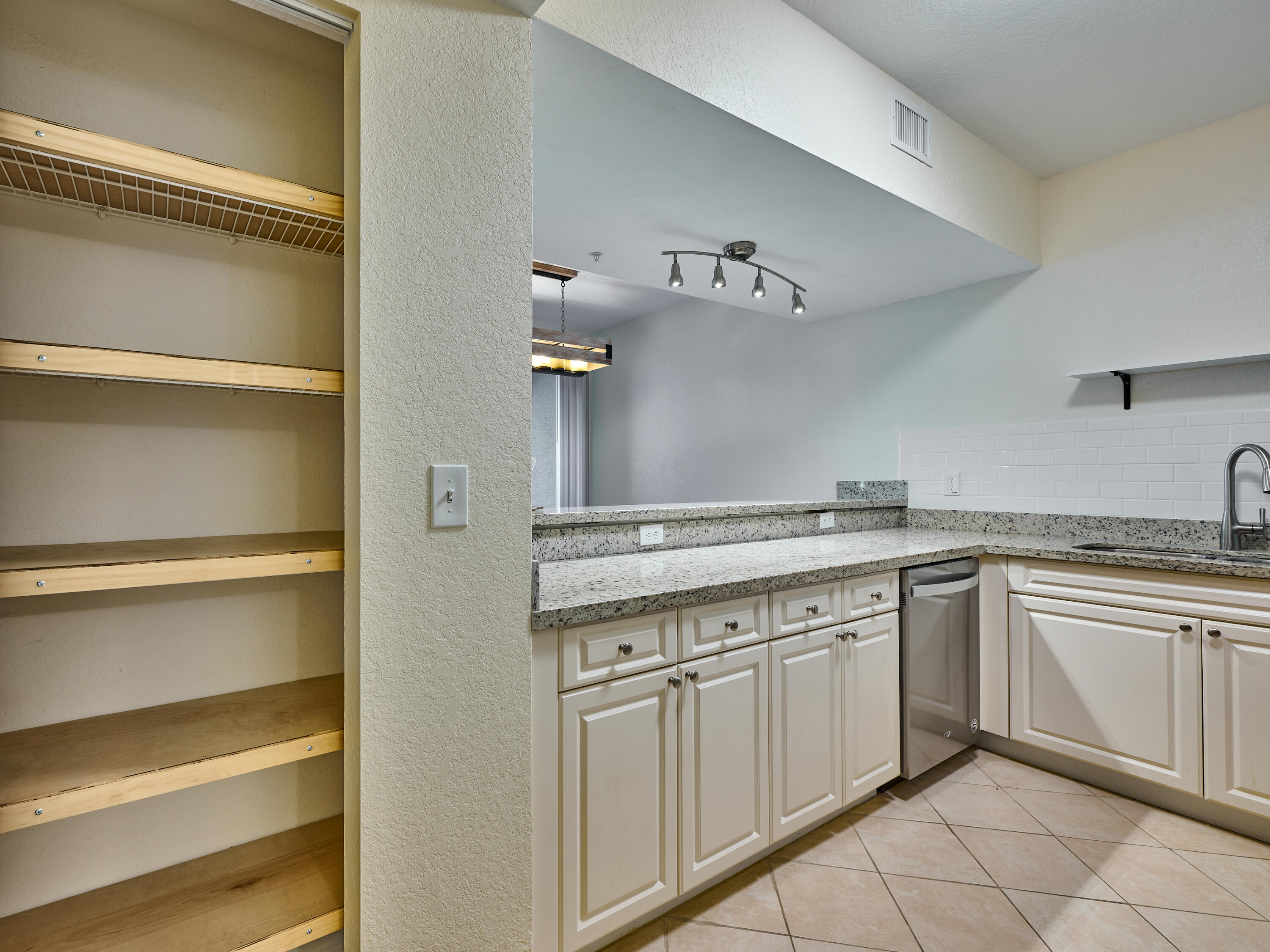 6344 West Sample Road, Unit 6344 Coral Springs, FL 33067 - Photo 15 of 30 a kitchen with cabinets appliances and a counter space