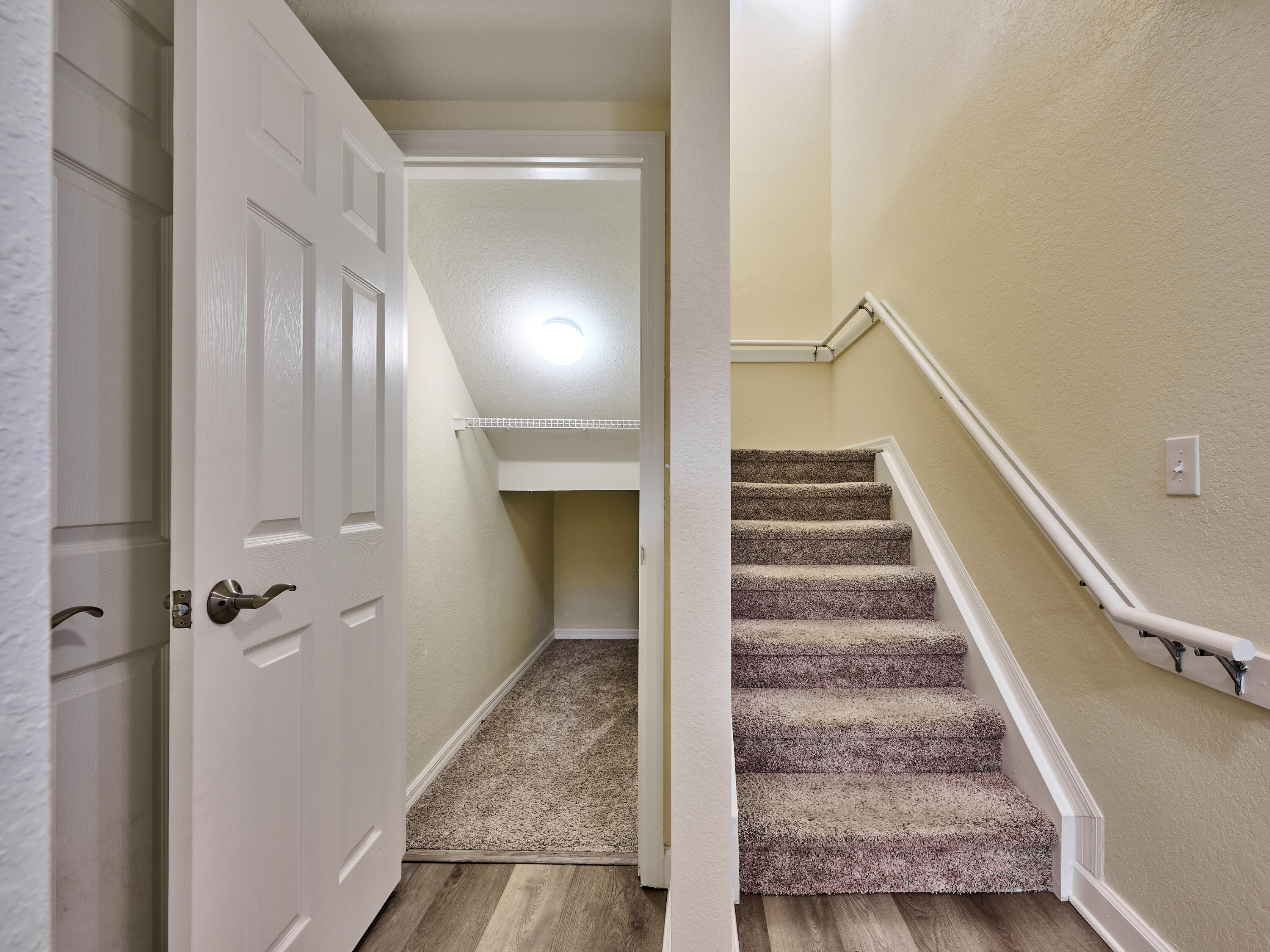 6344 West Sample Road, Unit 6344 Coral Springs, FL 33067 - Photo 17 of 30 a view of a hallway with entryway and wooden floor