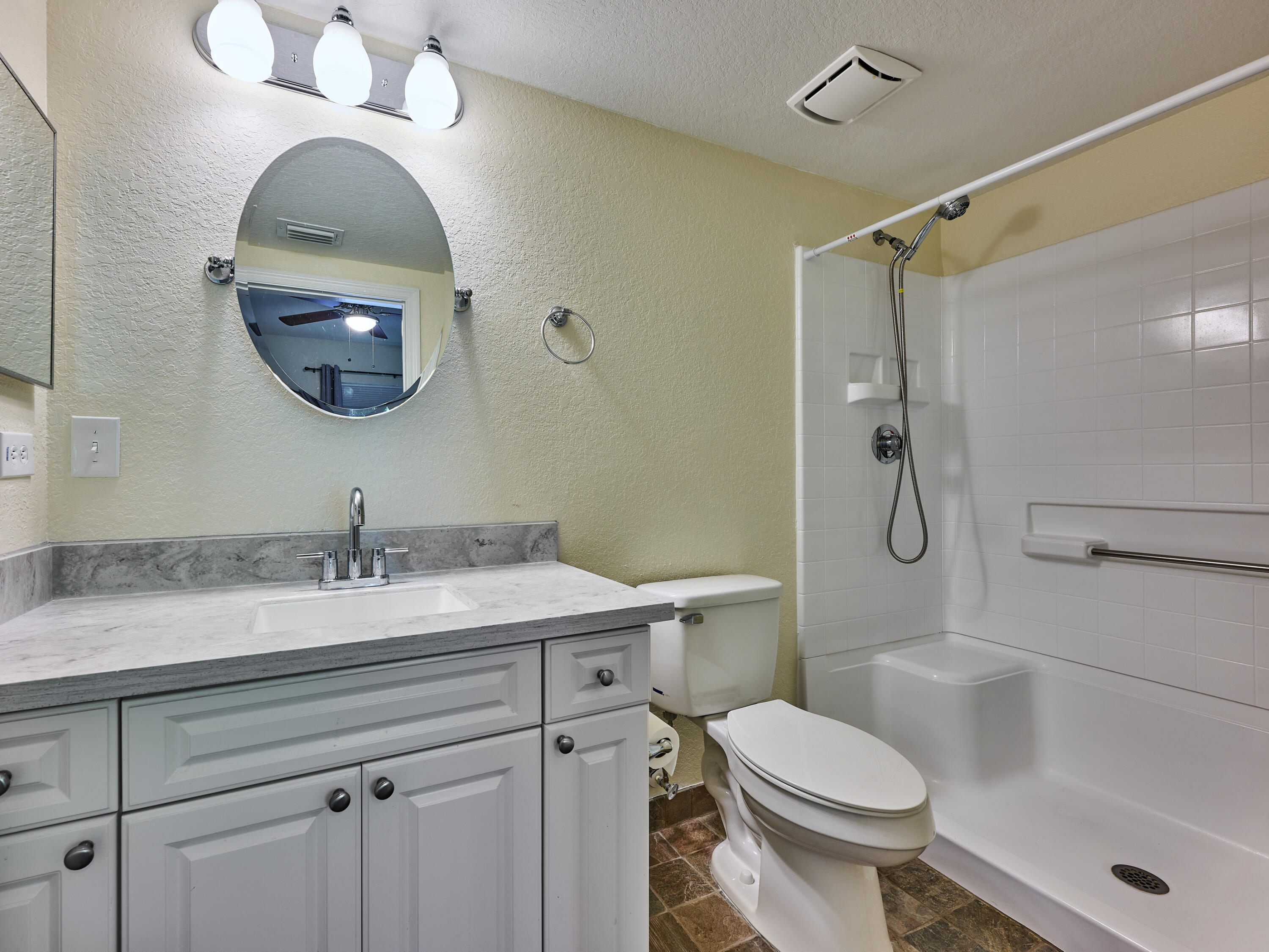 6344 West Sample Road, Unit 6344 Coral Springs, FL 33067 - Photo 23 of 30 a bathroom with a sink a toilet and a mirror