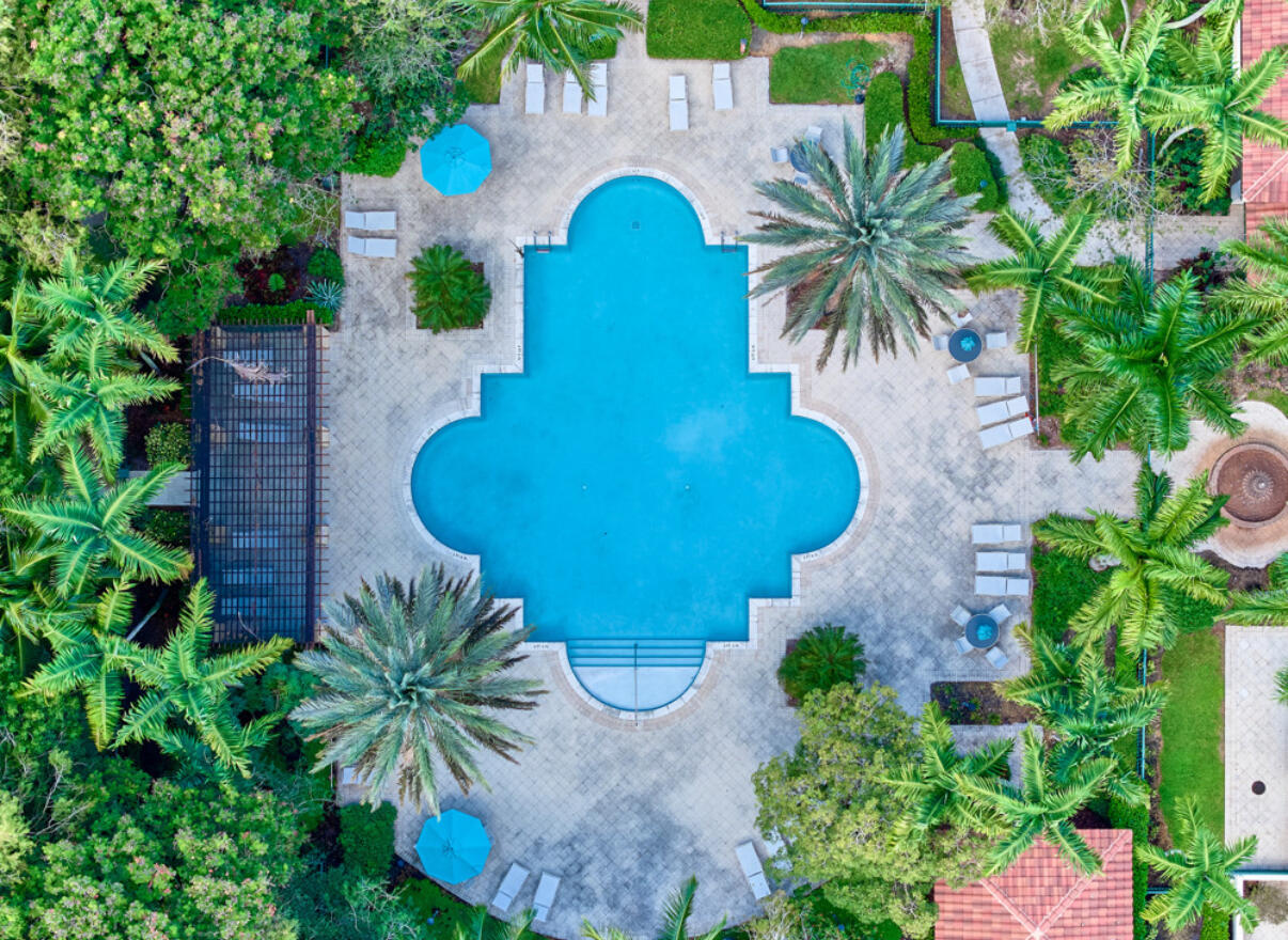 6344 West Sample Road, Unit 6344 Coral Springs, FL 33067 - Photo 26 of 30 an aerial view of a house with swimming pool and trees in the background