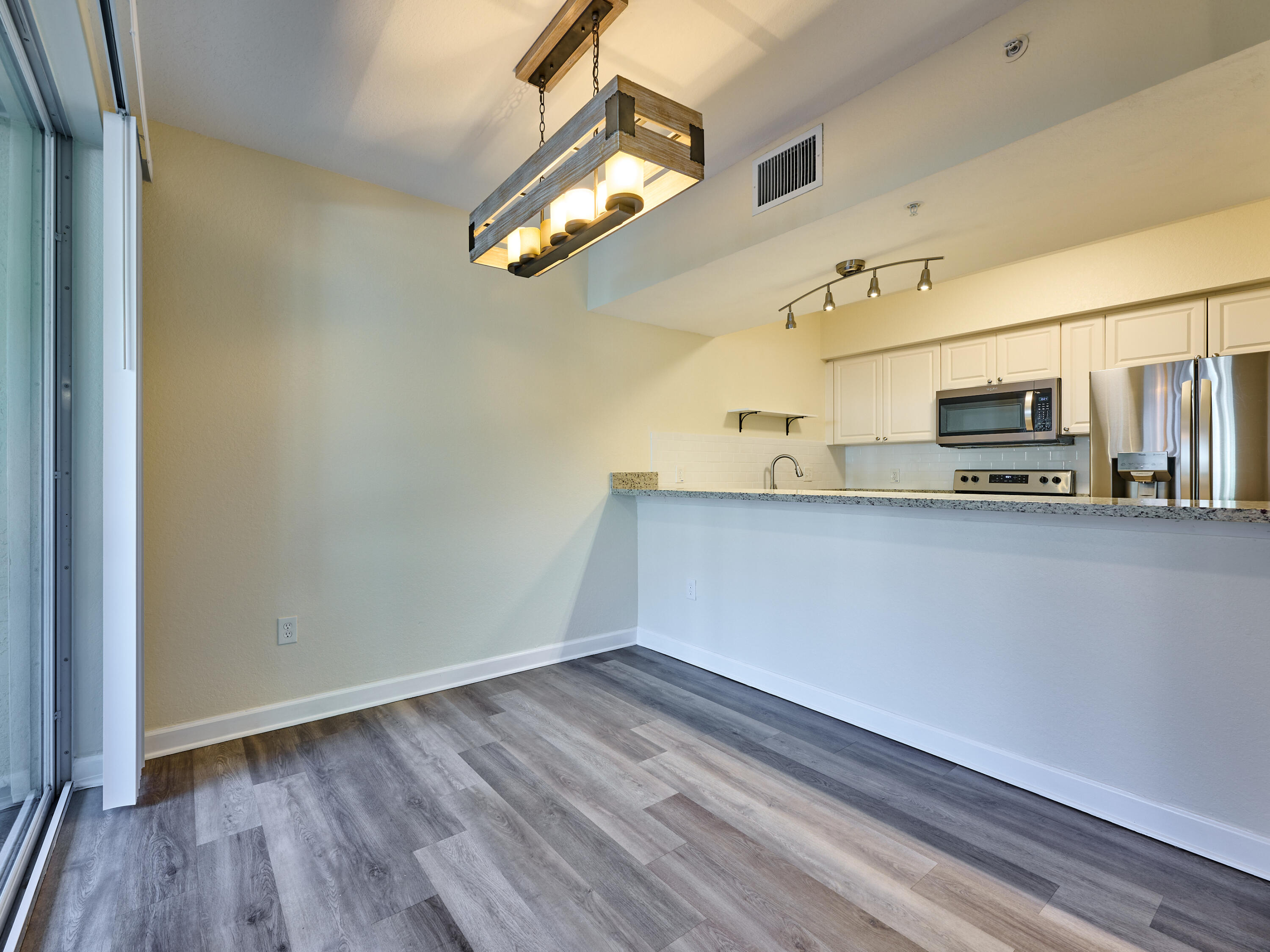 6344 West Sample Road, Unit 6344 Coral Springs, FL 33067 - Photo 7 of 30 a view of a kitchen with stainless steel appliances a wooden floor