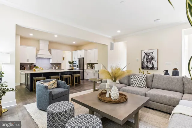 a living room with furniture kitchen view and a table