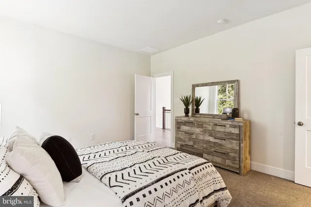 a bed room with a bed and a dresser