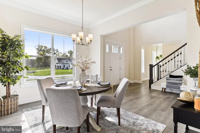 a view of a dining room with furniture wooden floor and chandelier