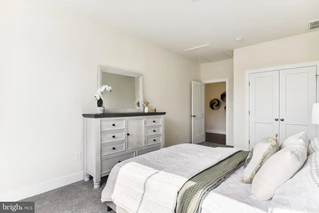 a bedroom with a bed and a dresser