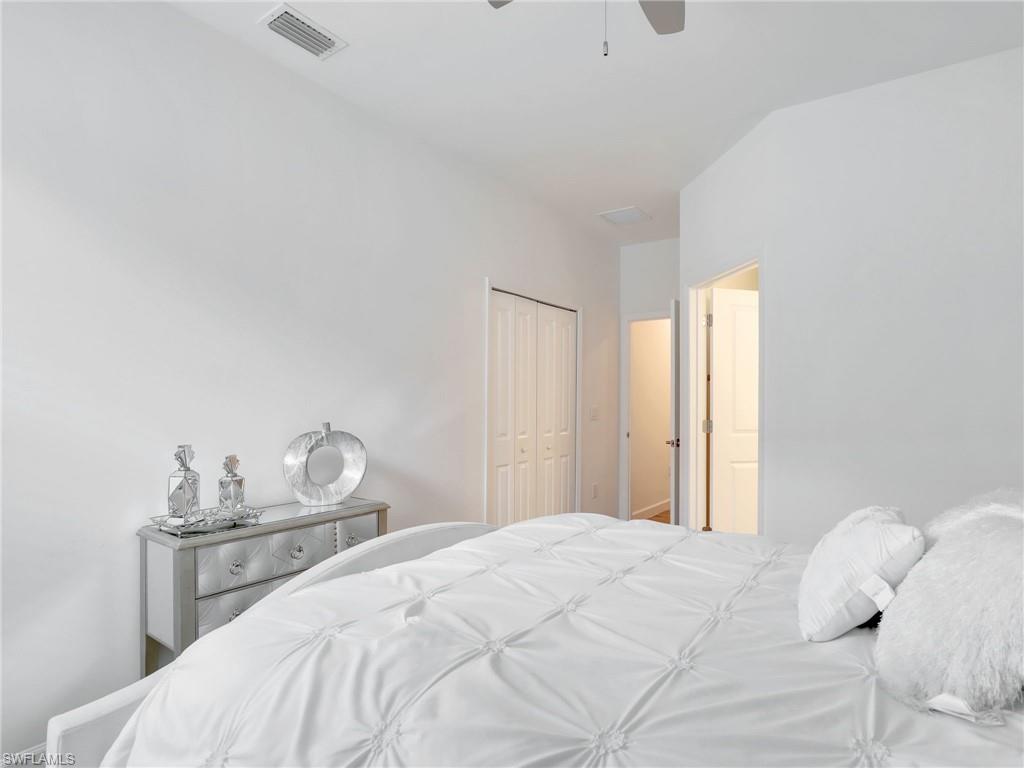 18278 Ridgeline Drive Estero, FL 33928 - Photo 22 of 45 a bedroom with a bed and a lamp