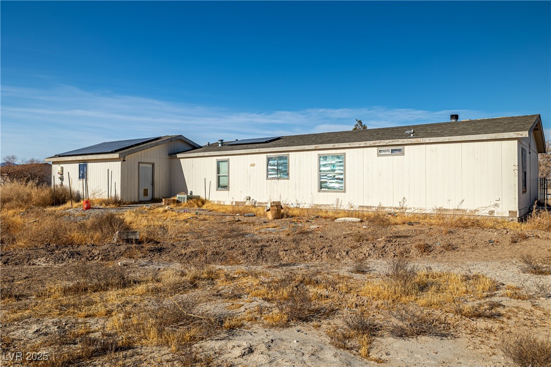 4231 West Wilson Road Pahrump, NV 89048 - Photo 15 of 15 View of side of home featuring roof mounted solar panels