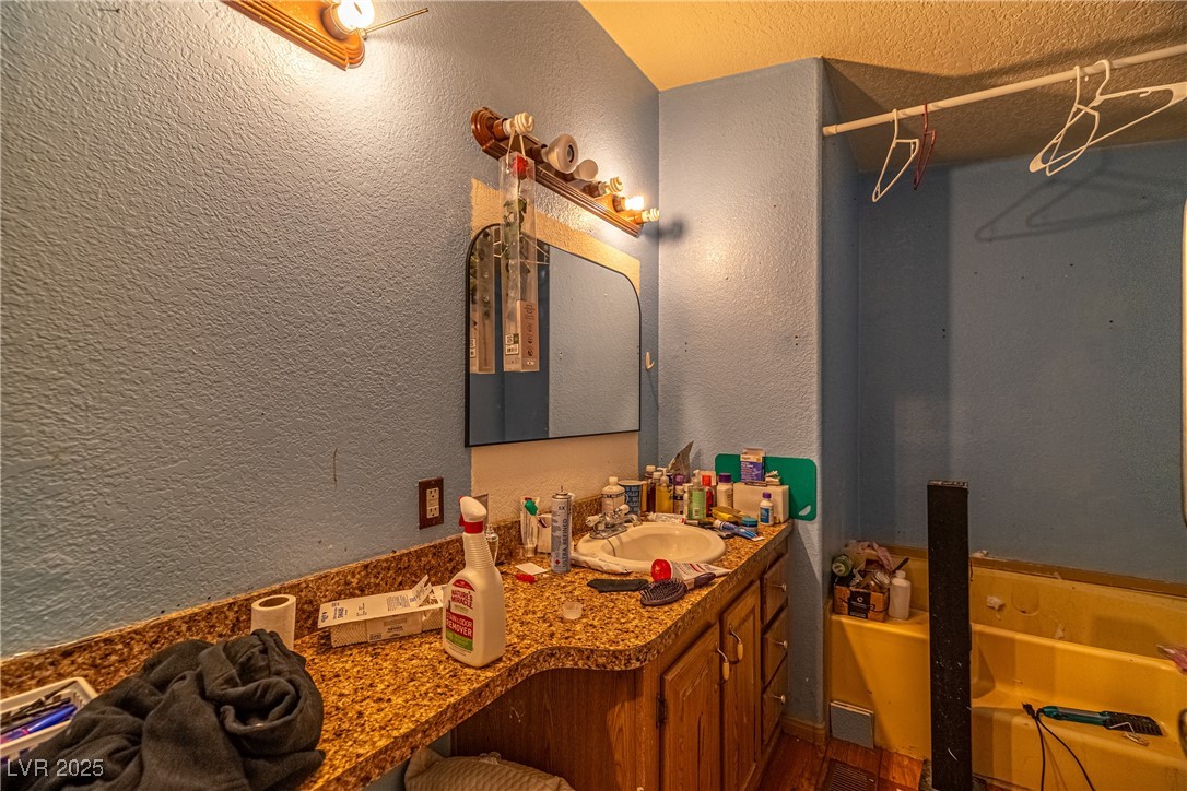 4231 West Wilson Road Pahrump, NV 89048 - Photo 10 of 15 Bathroom with vanity and a textured wall