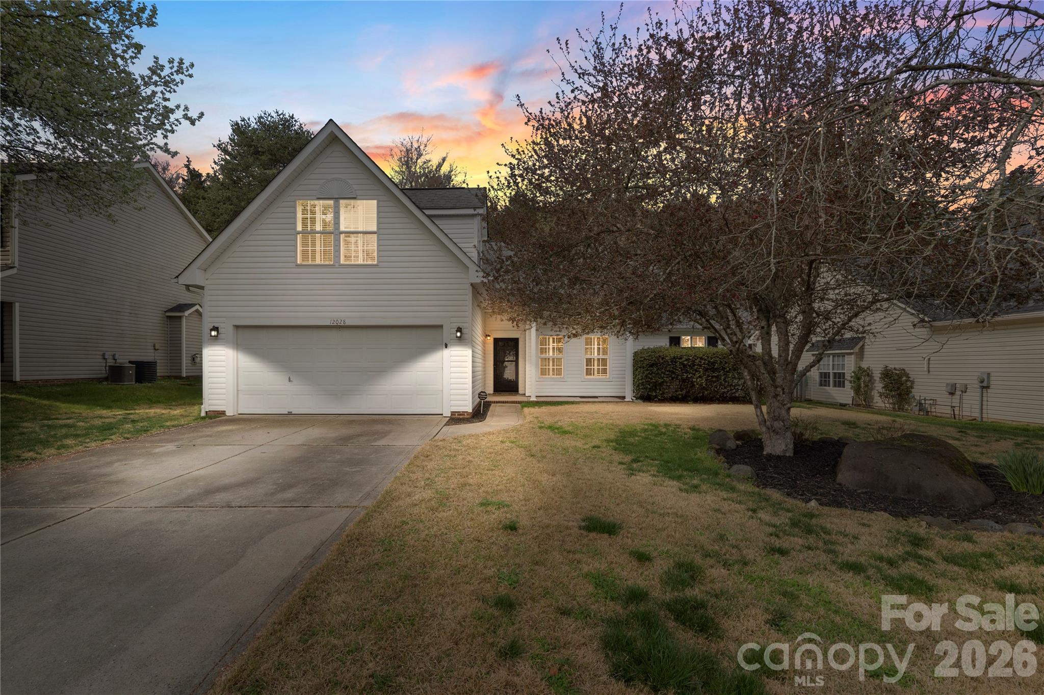 12028 Regent Ridge Lane Charlotte, NC 28278 - Photo 1 of 42 a front view of a house with a yard and garage
