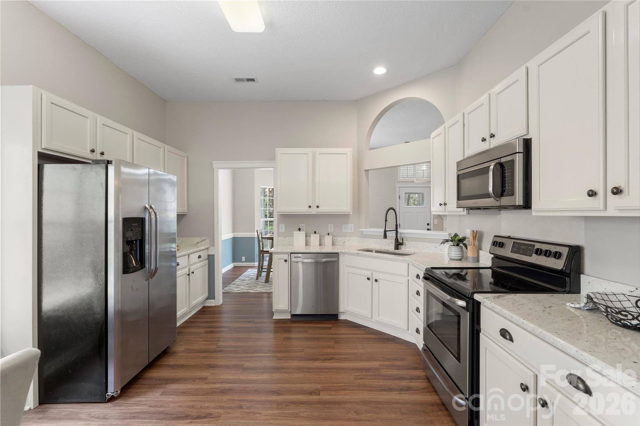 12028 Regent Ridge Lane Charlotte, NC 28278 - Photo 12 of 42 a kitchen with stainless steel appliances granite countertop a refrigerator stove microwave and sink