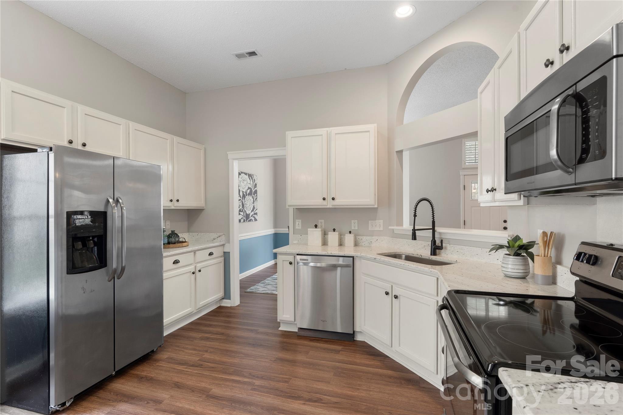 12028 Regent Ridge Lane Charlotte, NC 28278 - Photo 14 of 42 a kitchen with stainless steel appliances granite countertop a refrigerator stove a sink dishwasher and microwave oven with cabinets