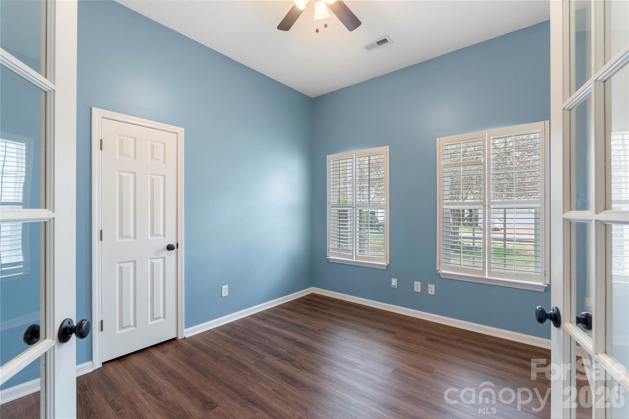 12028 Regent Ridge Lane Charlotte, NC 28278 - Photo 27 of 42 an empty room with wooden floor and windows