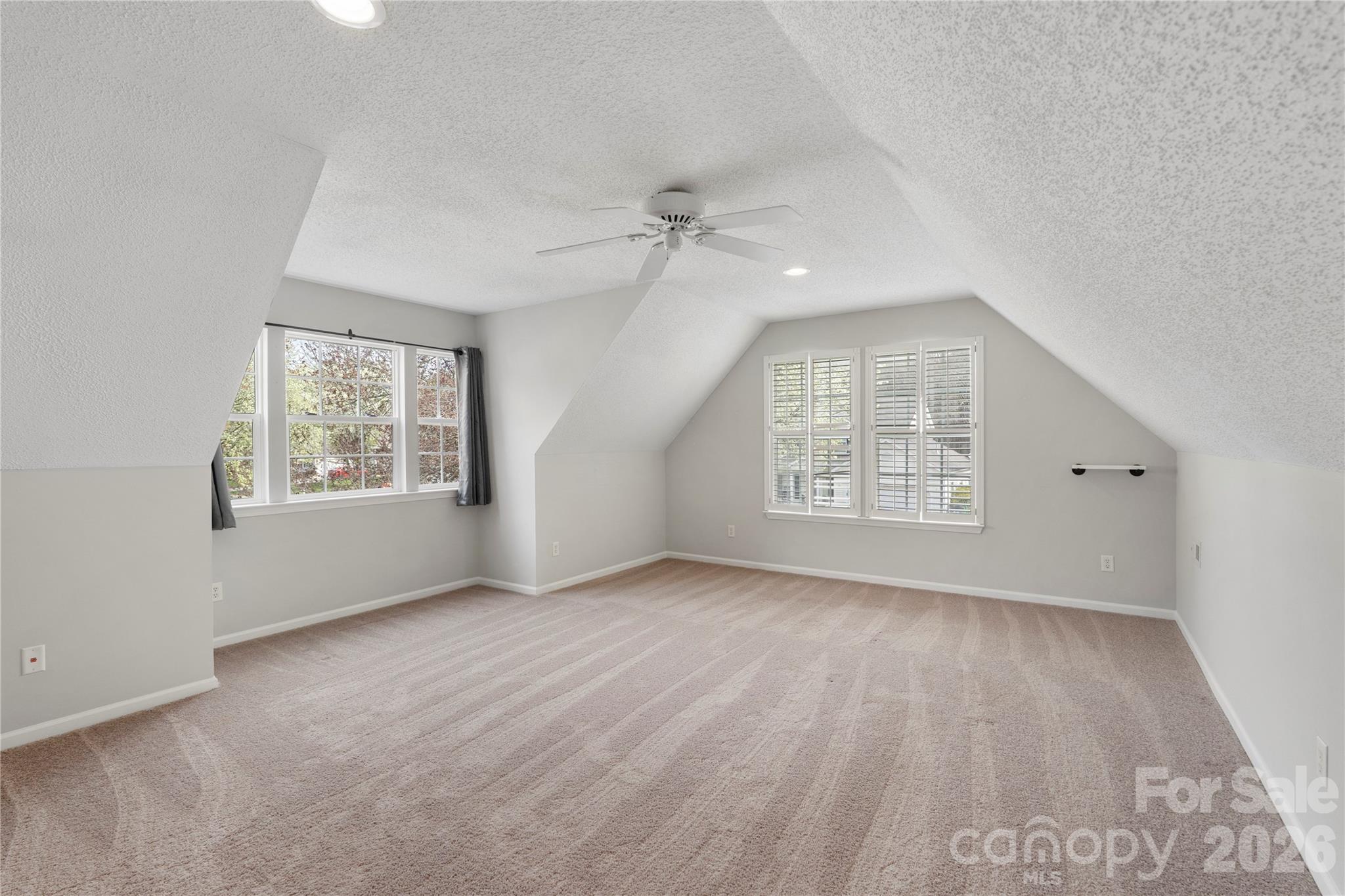 12028 Regent Ridge Lane Charlotte, NC 28278 - Photo 32 of 42 an empty room with windows and chandelier fan