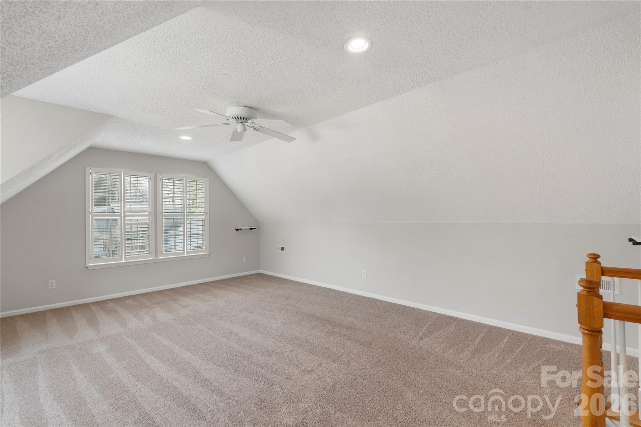 12028 Regent Ridge Lane Charlotte, NC 28278 - Photo 34 of 42 an empty room with windows and ceiling fan