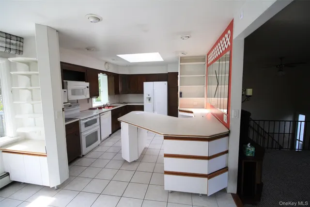 a kitchen with a sink appliances and cabinets