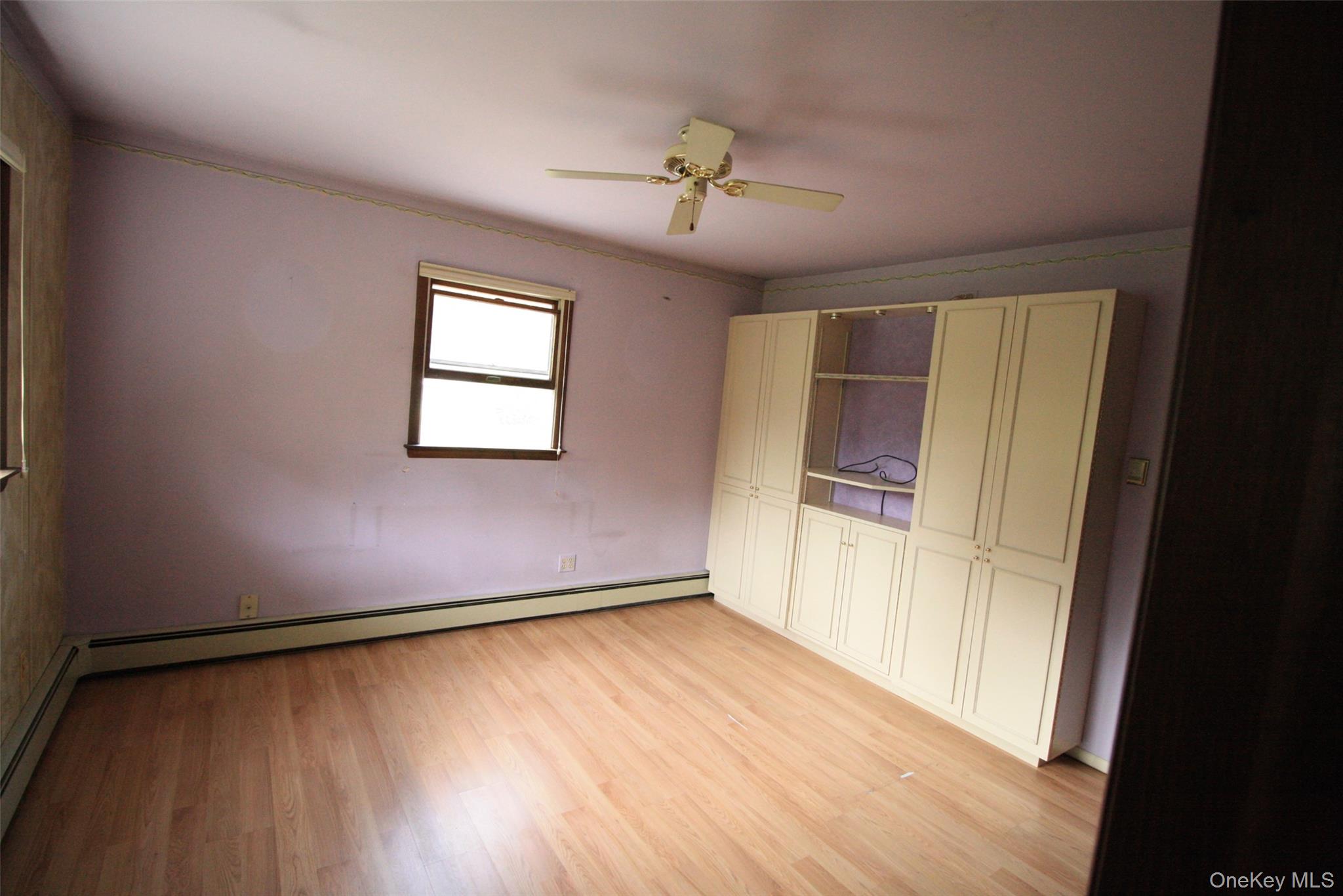 395 Mooney Hill Road Patterson, NY 12563 - Photo 18 of 26 an empty room with wooden floor and windows