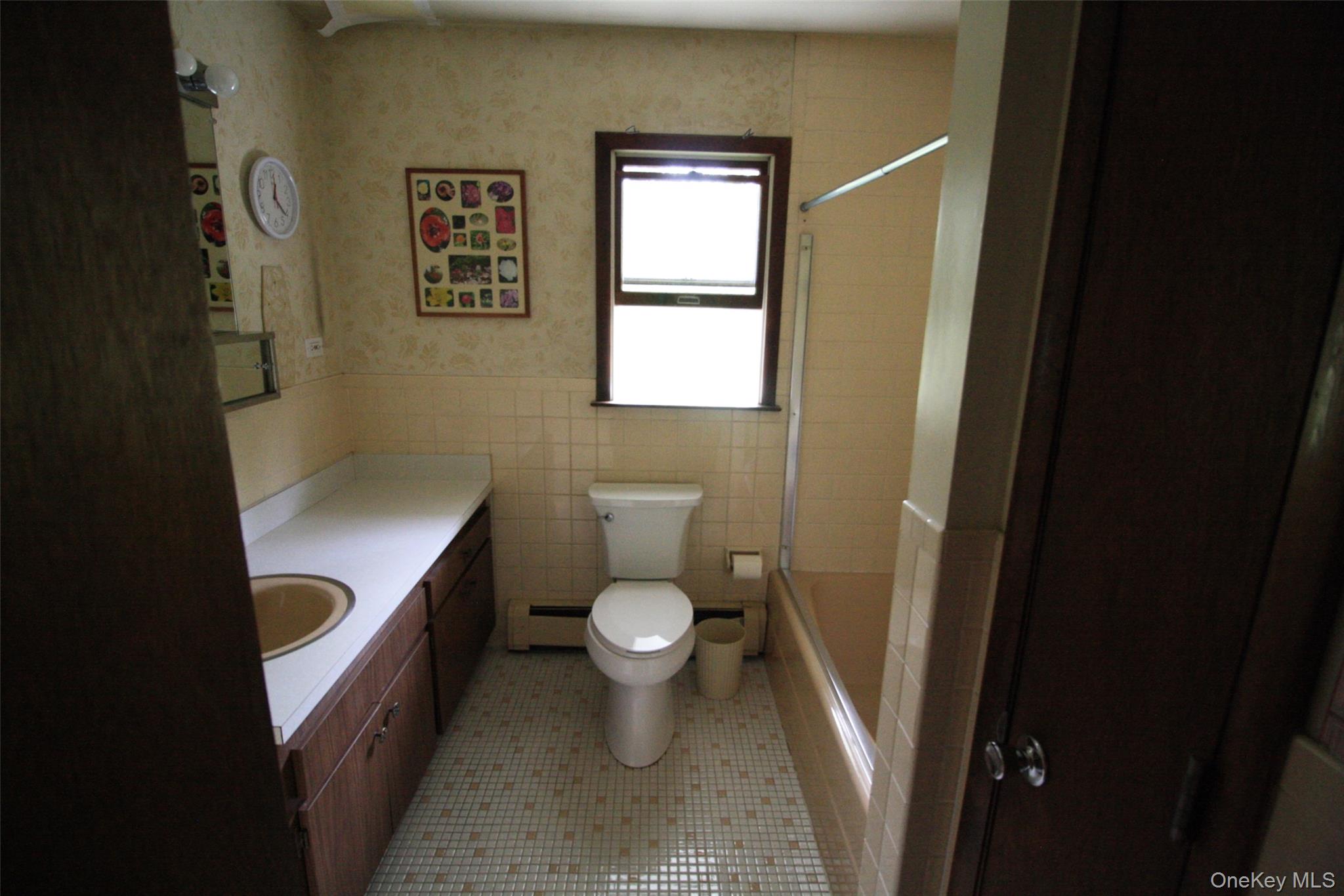 395 Mooney Hill Road Patterson, NY 12563 - Photo 20 of 26 a bathroom with a granite countertop toilet and a sink