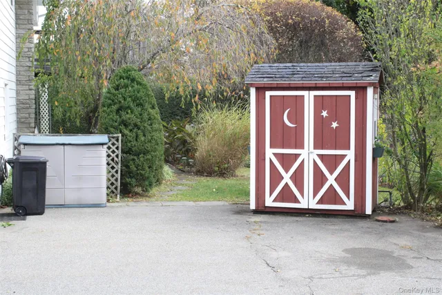 a backyard of a house with barbeque oven
