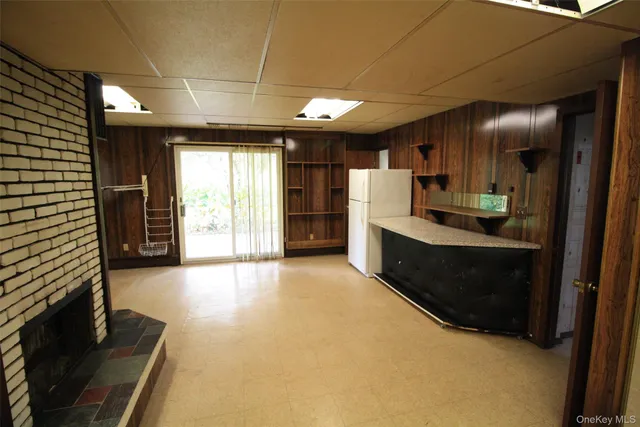 a kitchen with stainless steel appliances kitchen island granite countertop a refrigerator and a sink