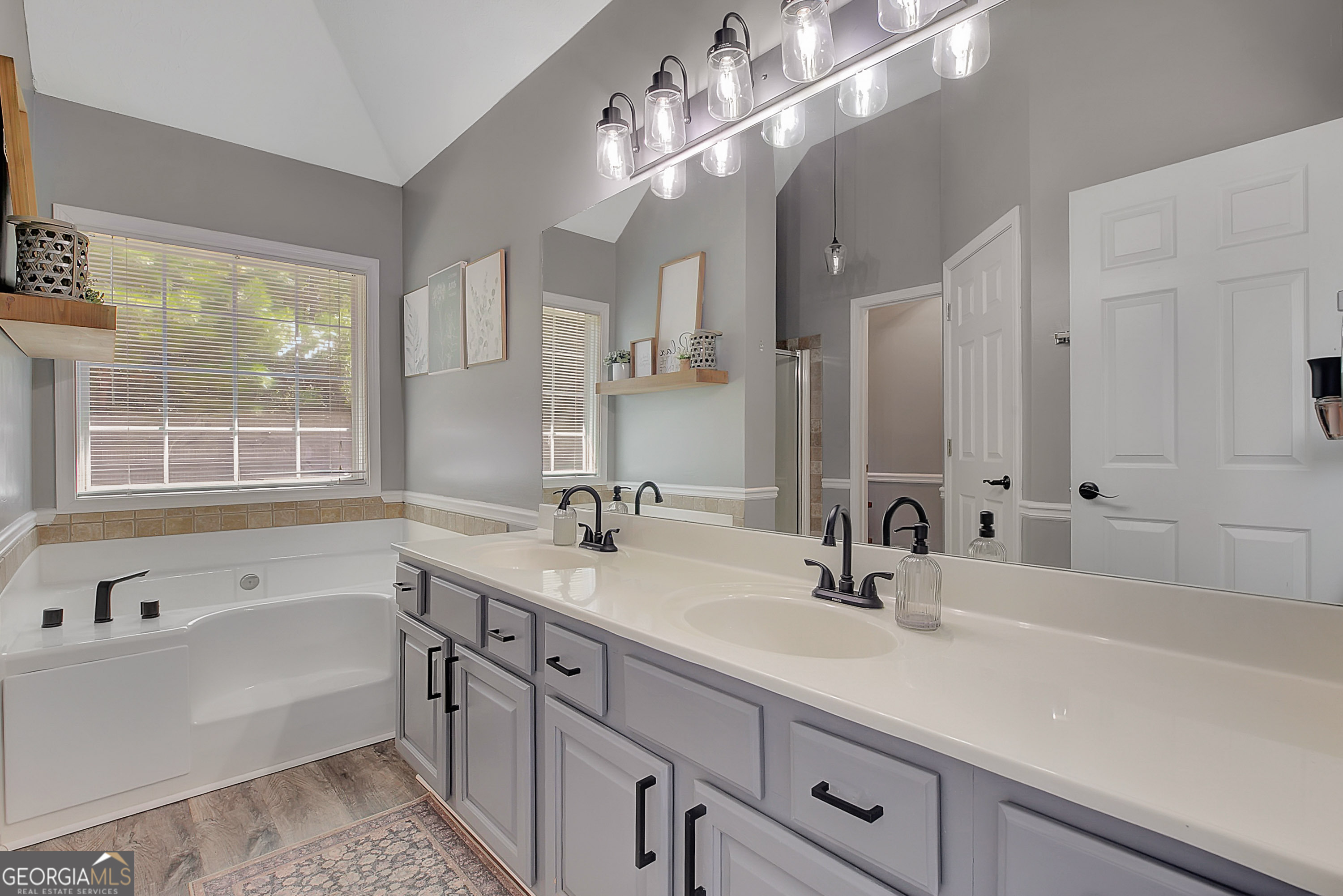 229 John Lovelace Road LaGrange, GA 30241 - Photo 16 of 59 a bathroom with a tub a sink double vanity granite and a mirror