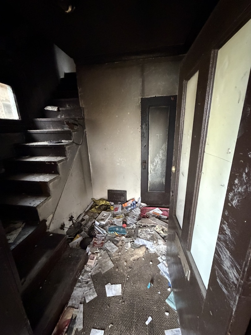 7927 South Colfax Avenue Chicago, IL 60617 - Photo 6 of 10 a bed sitting in a bedroom next to a window