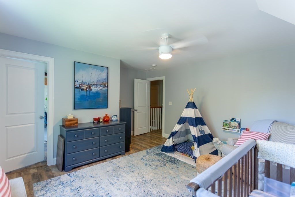 46 True Road Salisbury, MA 01952 - Photo 16 of 25 a bed room with furniture and wooden floor