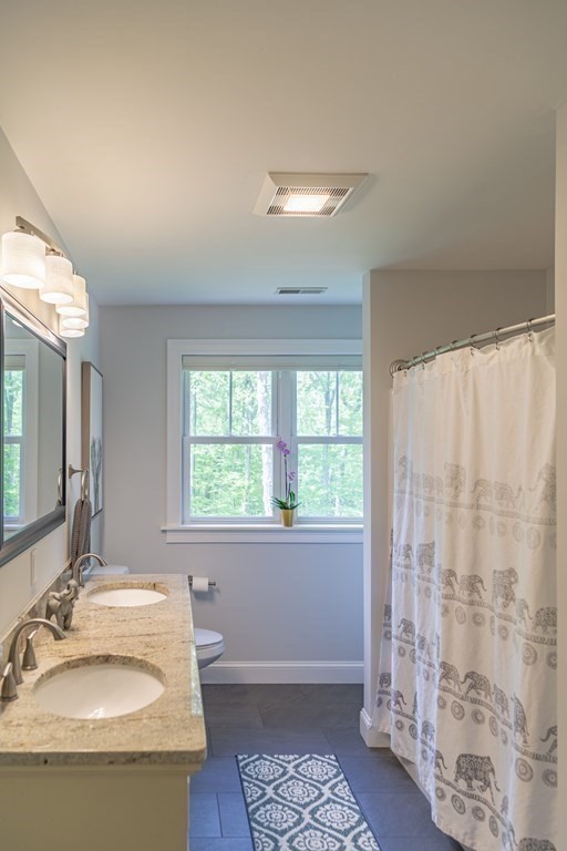 46 True Road Salisbury, MA 01952 - Photo 17 of 25 a bathroom with a sink and a mirror