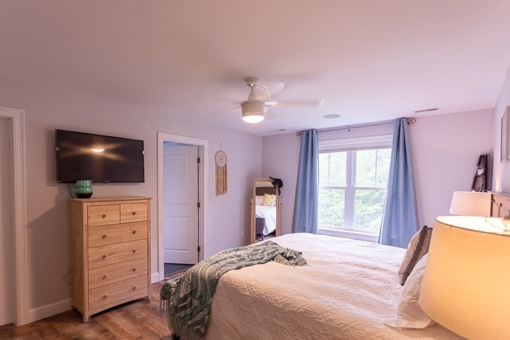 46 True Road Salisbury, MA 01952 - Photo 18 of 25 a bedroom with a bed and a flat screen tv