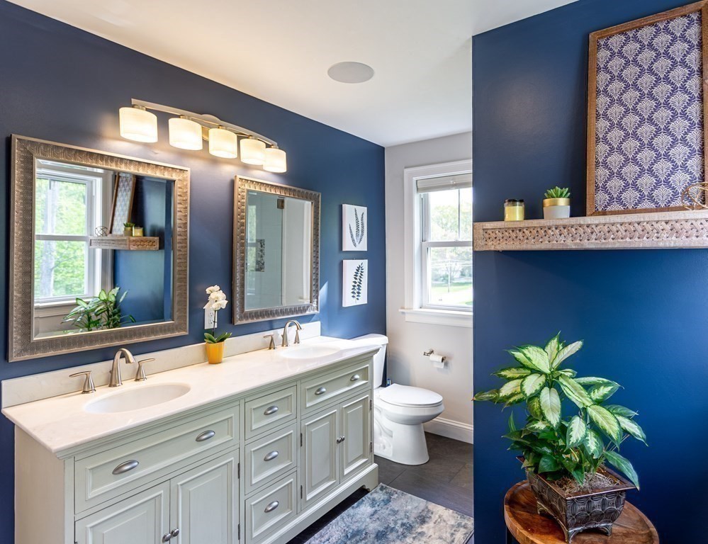 46 True Road Salisbury, MA 01952 - Photo 21 of 25 a bathroom with a granite countertop toilet a sink and a large mirror