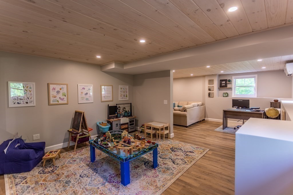 46 True Road Salisbury, MA 01952 - Photo 24 of 25 a living room with furniture a rug and white walls