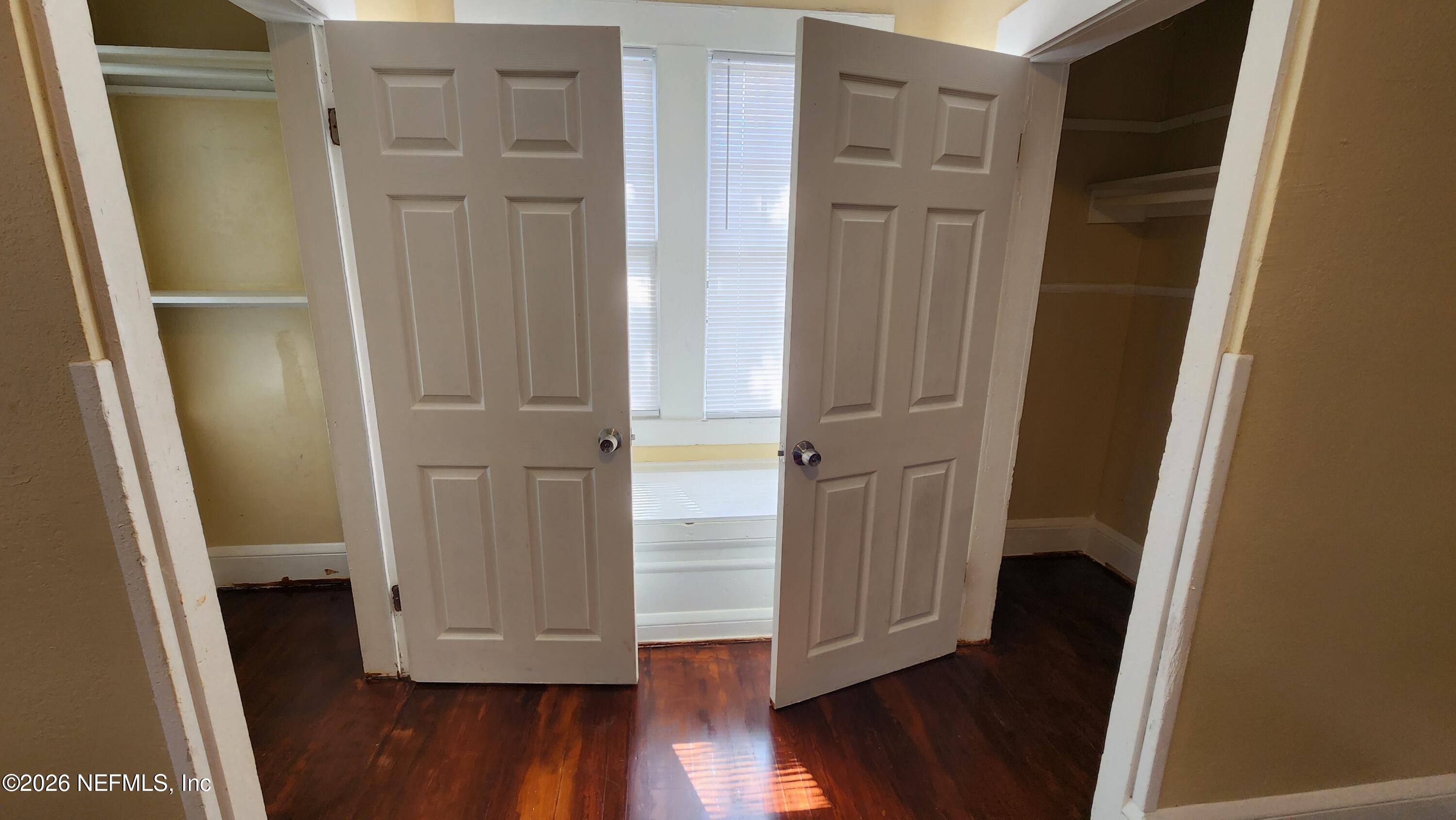 2036 Moncrief Road Jacksonville, FL 32209 - Photo 16 of 32 an empty room with wooden floor and closet area