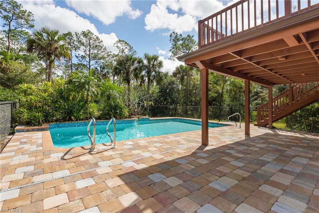 480 9th Street Southwest Naples, FL 34117 - Photo 4 of 11 POOL WITH WATERFALL AND EXTENDED LANAI FOR ENTERTAINING