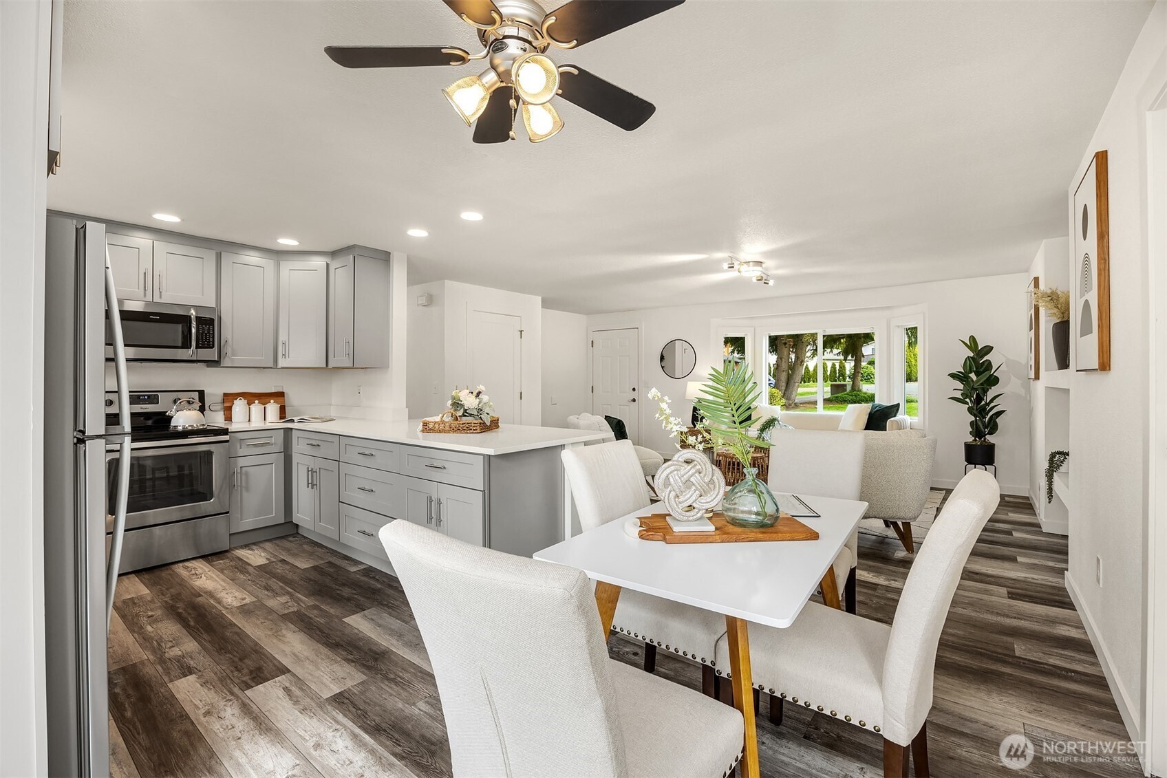 2208 182nd Street Southeast Bothell, WA 98012 - Photo 3 of 24 a view of a dining room with furniture a kitchen and chandelier